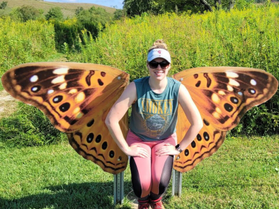 Woman poses in front of butterfly wings at Hocking Hills State Park