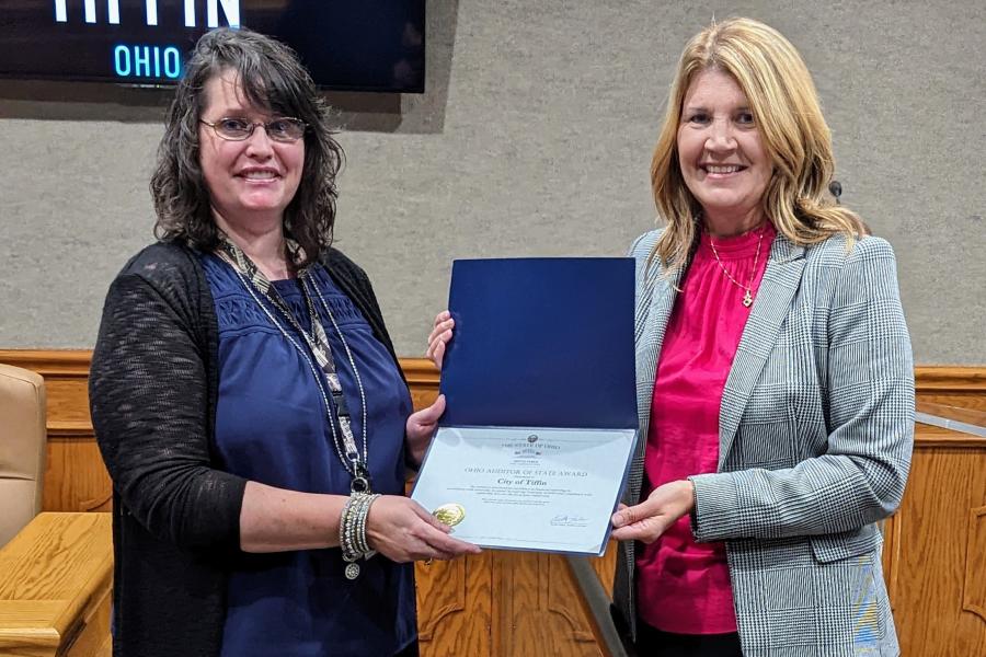 Lori Brodie, Northwest Regional Liaison for Auditor of State Keith Faber, presents Director of Finance Kathy Kaufman with the Auditor of State Award
