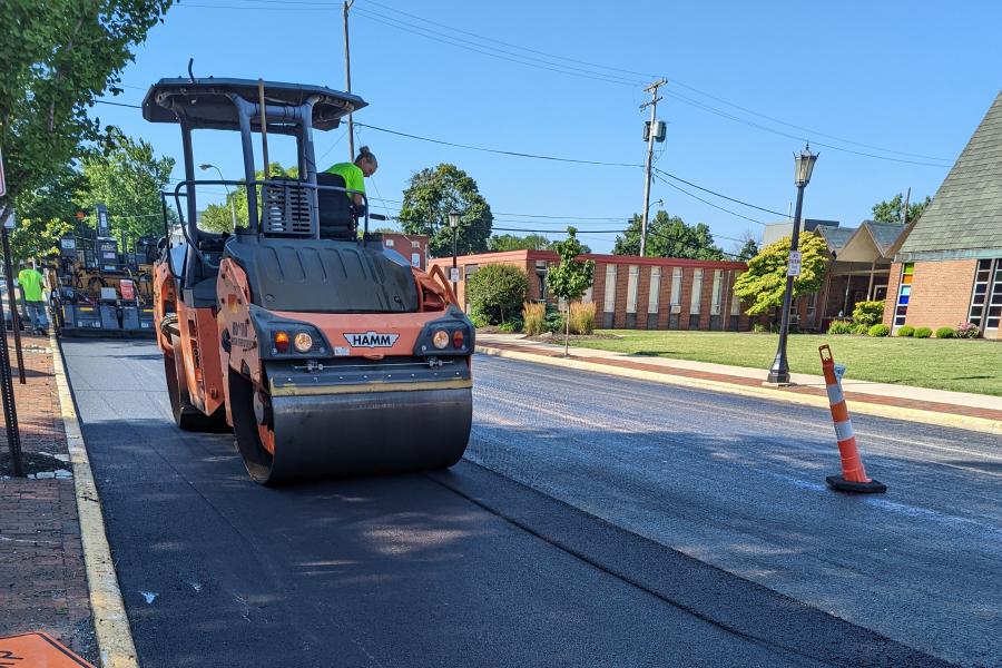 A crew from Helms and Sons Excavating paves Monroe Street as part of the 2022 paving program.