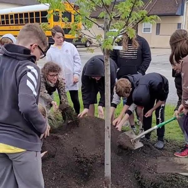 Children gather to plant a tree during the 2023 Tiffin Arbor Day Celebration